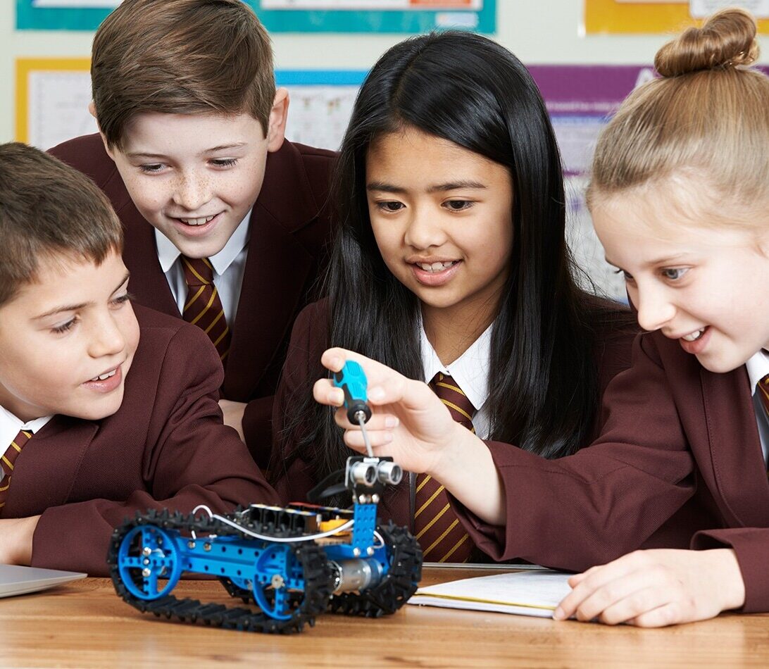 School students working with laptop for robotics STEM